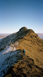 Scenic view of man on rocky mountain