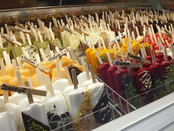 Close-up of different kind of icecream on sticks for sale