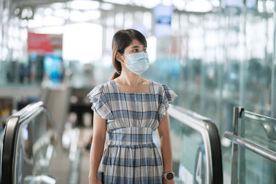 Portrait of woman standing in bus