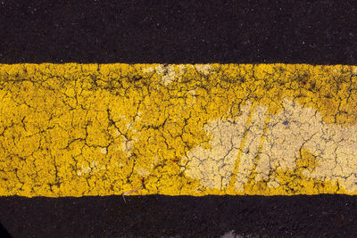 High angle view of yellow road sign on street