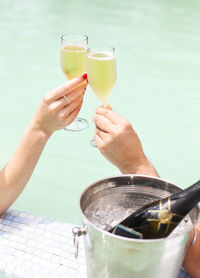 Midsection of person holding drink drinking glass