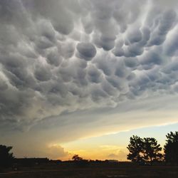 Scenic view of dramatic sky over silhouette landscape