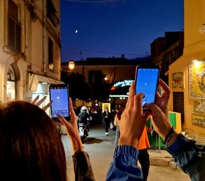 Rear view of woman using digital tablet