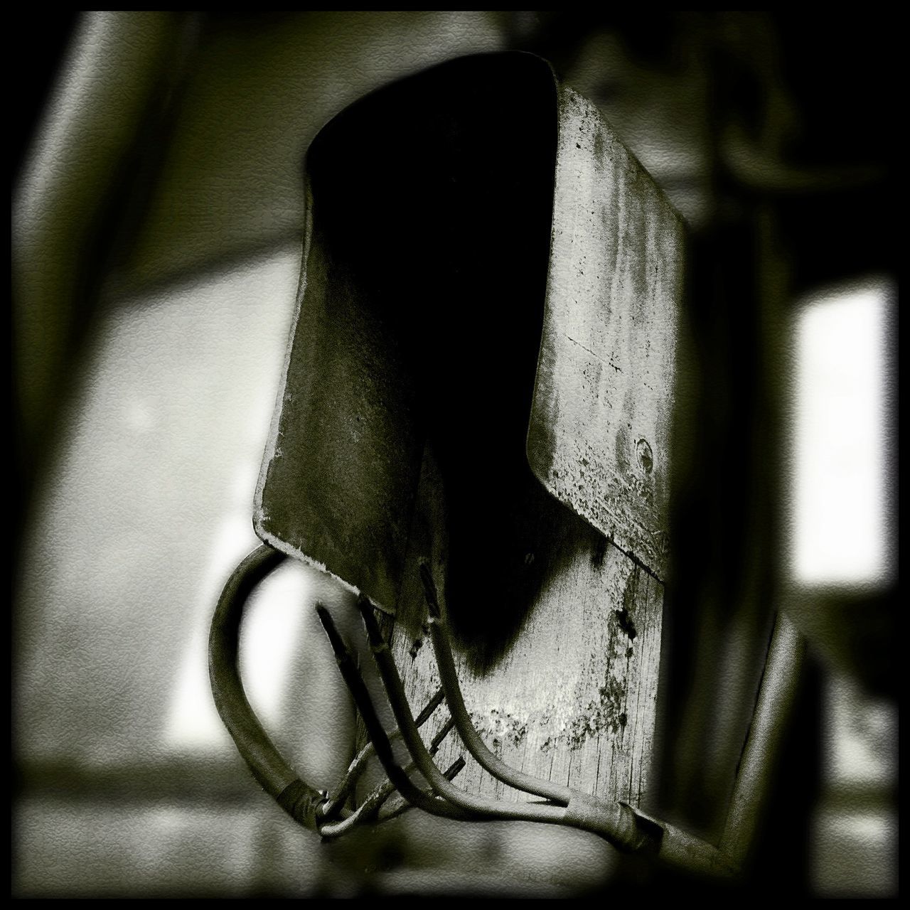 close-up, transfer print, auto post production filter, indoors, high angle view, shadow, still life, selective focus, wall - building feature, old, no people, single object, focus on foreground, metal, part of, shoe, black color, sunlight, day, human representation