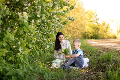 Cute boy with mom on a picnic. son hugs mom