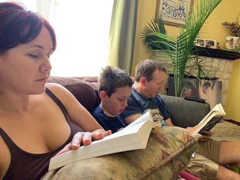 Rear view of people sitting at home