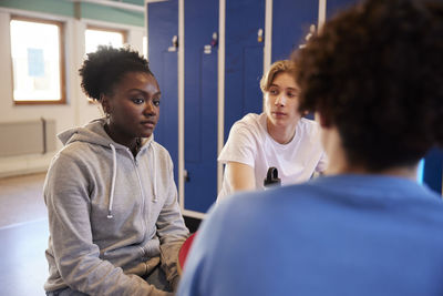 Teenagers talking in locker room