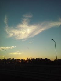 Low angle view of silhouette trees against sky