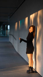 Full length of young woman standing in city