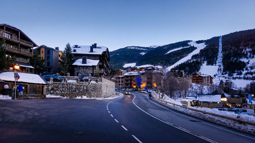 Road in city against clear sky during winter