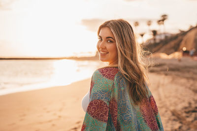 Young woman standing at beach