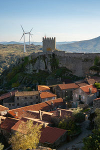 View of sortelha castle and antique stone houses and wind turbines, in portugal