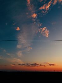 Scenic view of silhouette field against sky during sunset