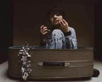 Portrait of boy sitting on table