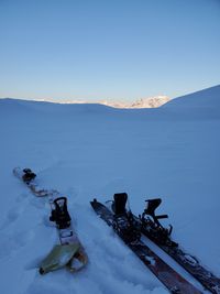 Scenic view of snow covered mountains against clear blue sky