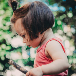 Side view of toddler holding stick