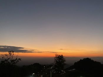 Silhouette trees against sky during sunset