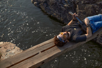 High angle view of woman relaxing on wood