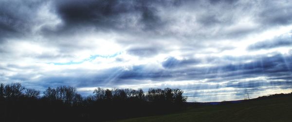 Scenic view of field against cloudy sky