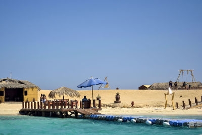 People rest on beach on sunny day. beach holidays, relaxation, swimming in the red sea.