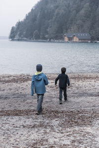 Rear view of friends walking on land