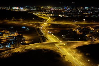 Illuminated street in city at night