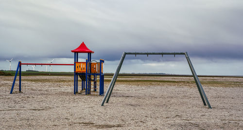 Lifeguard hut on beach against sky