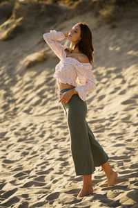 Smiling woman standing on beach