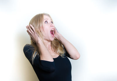 Portrait of young woman against white background