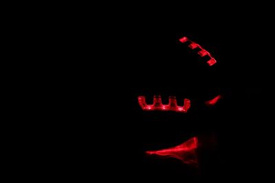 Close-up of illuminated text in darkroom