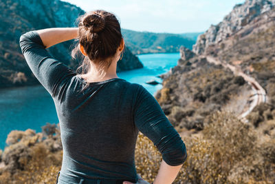 Rear view of woman standing on mountain