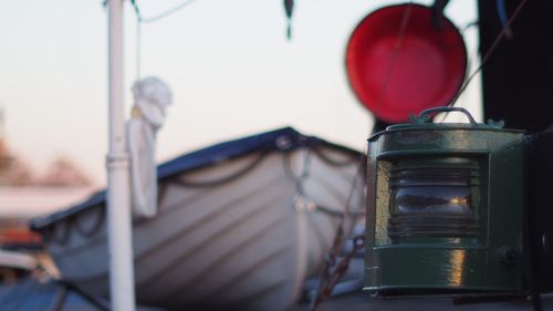 Close-up of oil lamp lantern against boat