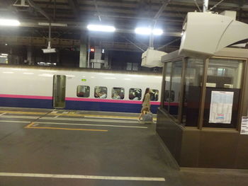 Train at railroad station platform at night