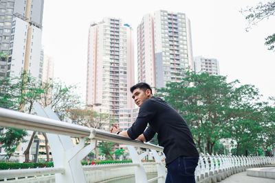 Full length of a young man in city against buildings