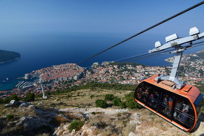 Cable car over sea against sky