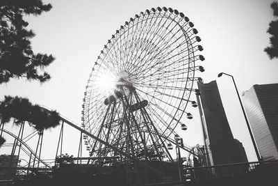 Low angle view of ferris wheel against sky