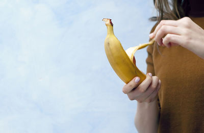 Woman opening banana