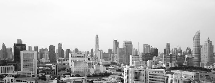 Buildings in city against clear sky