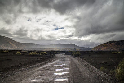 Road amidst mountains against sky