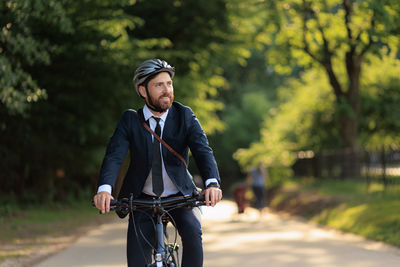 Portrait of man riding bicycle on road