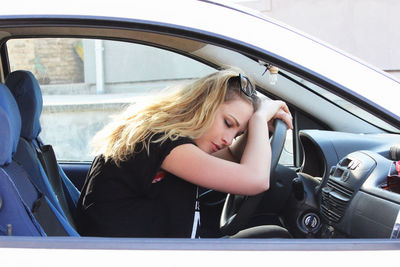 Portrait of woman sitting in car