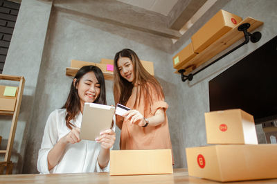 Young woman using mobile phone in building