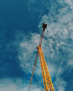 Low angle view of crane against sky