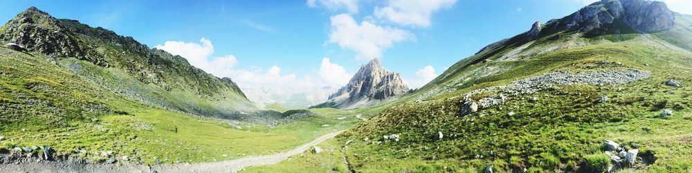 Panoramic view of road amidst mountains against sky