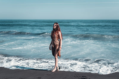 Full length of young woman at beach