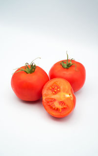 Close-up of tomatoes against white background