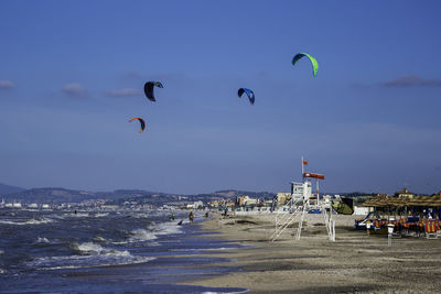 People on beach against sky