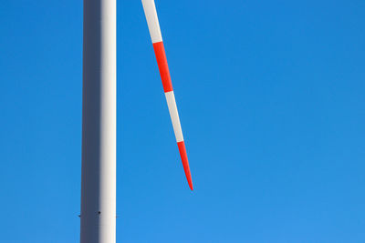 Low angle view of pole against clear blue sky