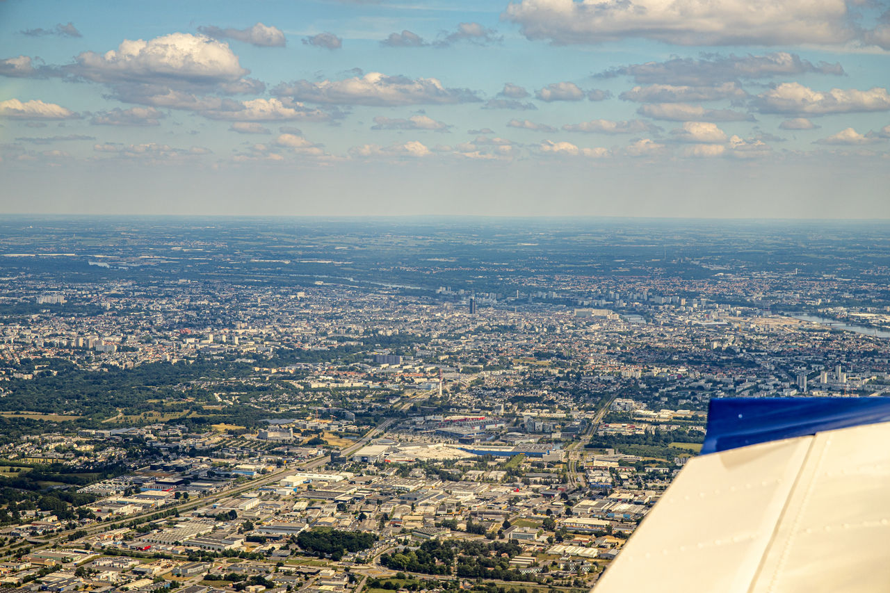 AERIAL VIEW OF CITYSCAPE AND AIRPLANE