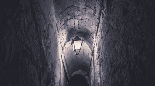 Illuminated light on wall in old building